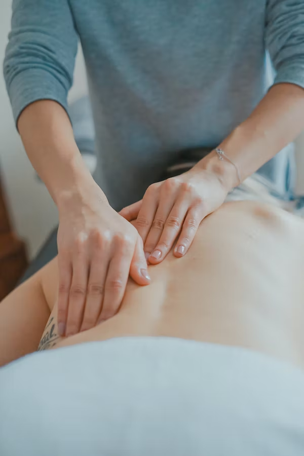 a person getting massaged on the back